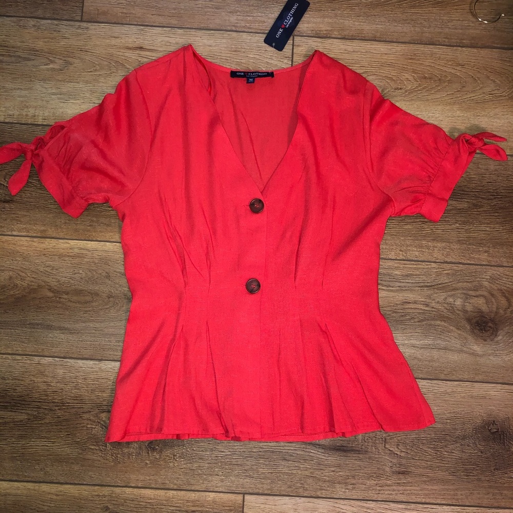 Hot pink shirt with the tags still on.